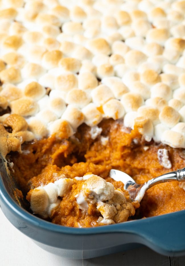 southern sweet potato casserole with marshmallows - spooned out of baking dish