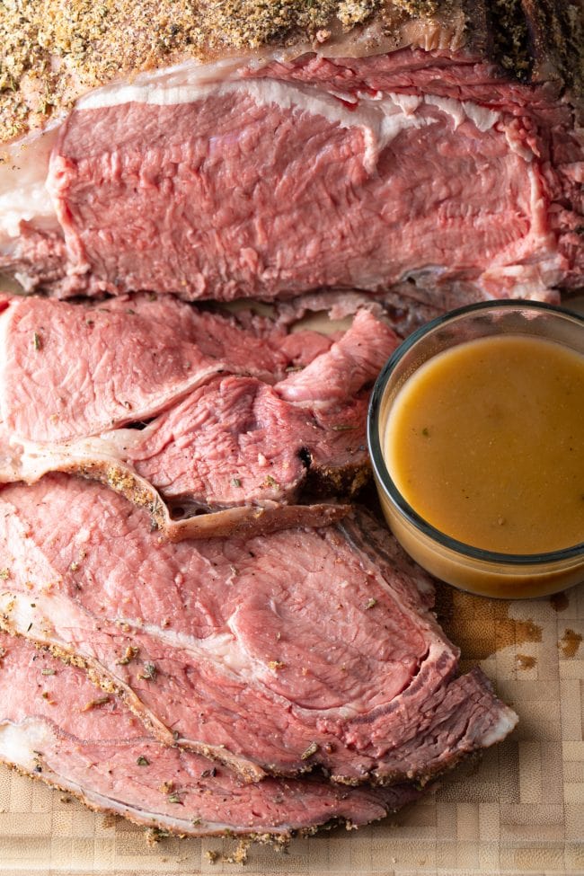 smoked prime rib au jus - close up of sliced medium-rare rib roast