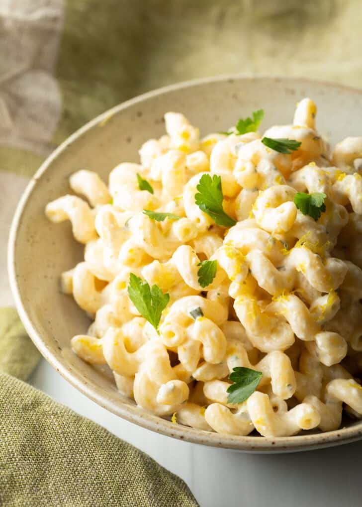 Large bowl of Boursin cheese pasta garnished with chopped parsley.