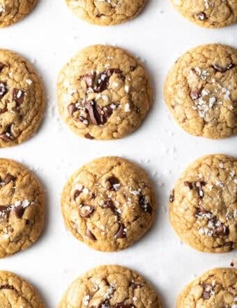 Top down view 12 chocolate chip cookies on a baking sheet.