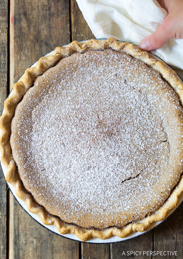 Overhead shot of cinnamon pie with powdered sugar dusted on top. 