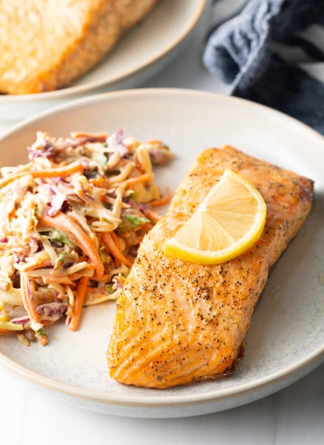 Plate of salmon with coleslaw.