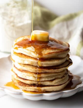 A fluffy stack of pancakes with butter and syrup, made with a homemade pancake mix recipe.