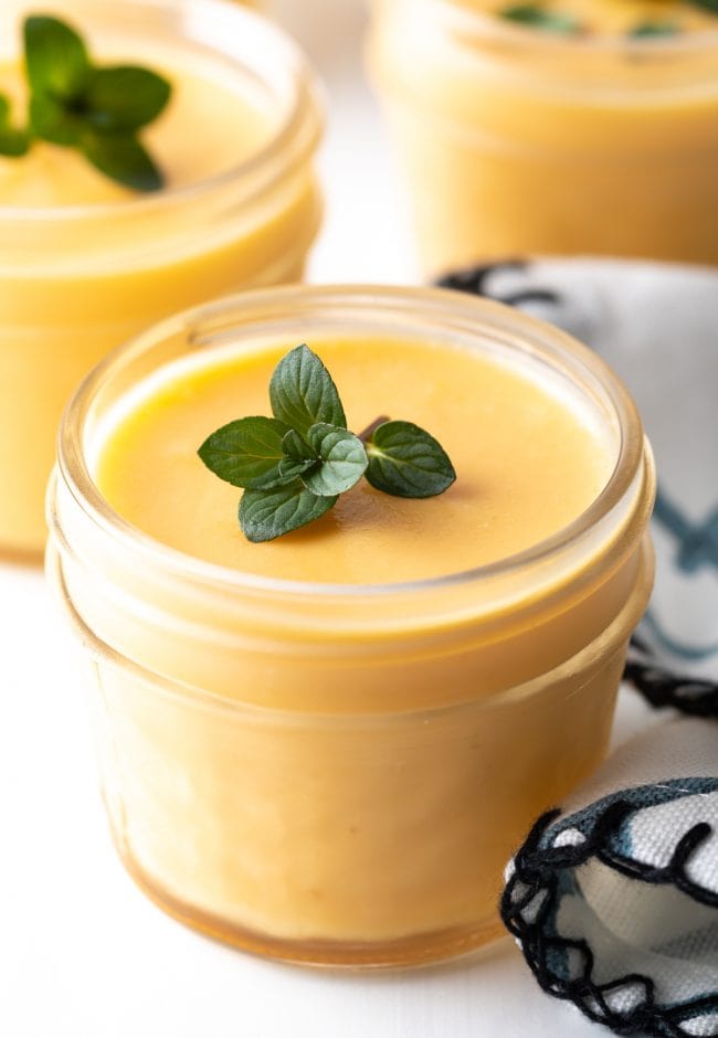 Closeup of dairy free mango pudding with fresh mint leaves.