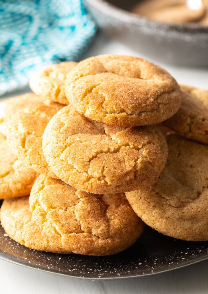 Plate with a dozen biscochitos stacked.