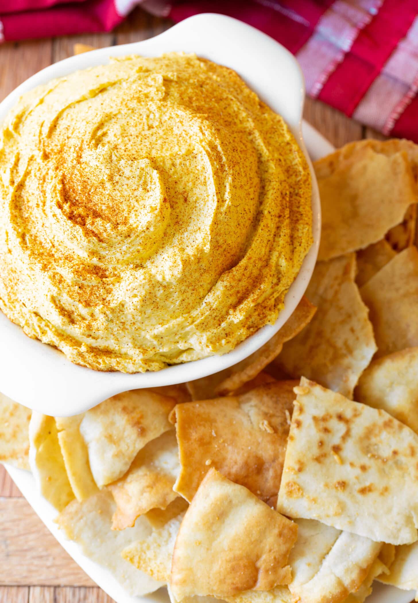 Irish Pub Cheese AKA Beer Cheese in a small crock next to pita chips. 