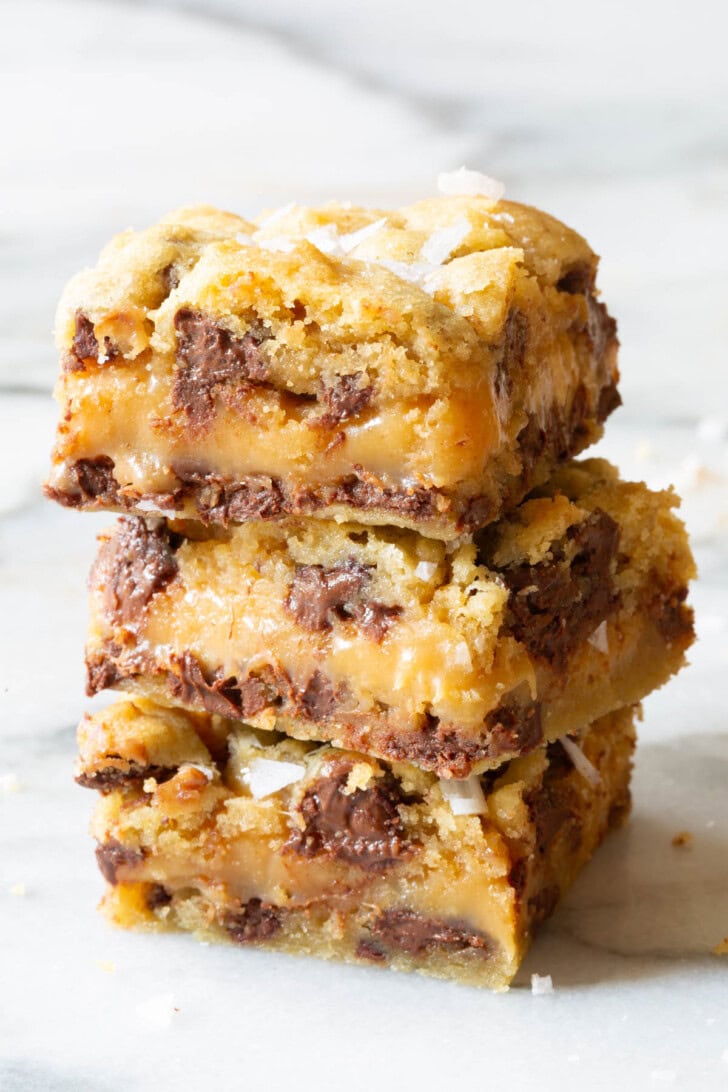 Caramel chocolate chip cookies bars stacked on top of each other. 