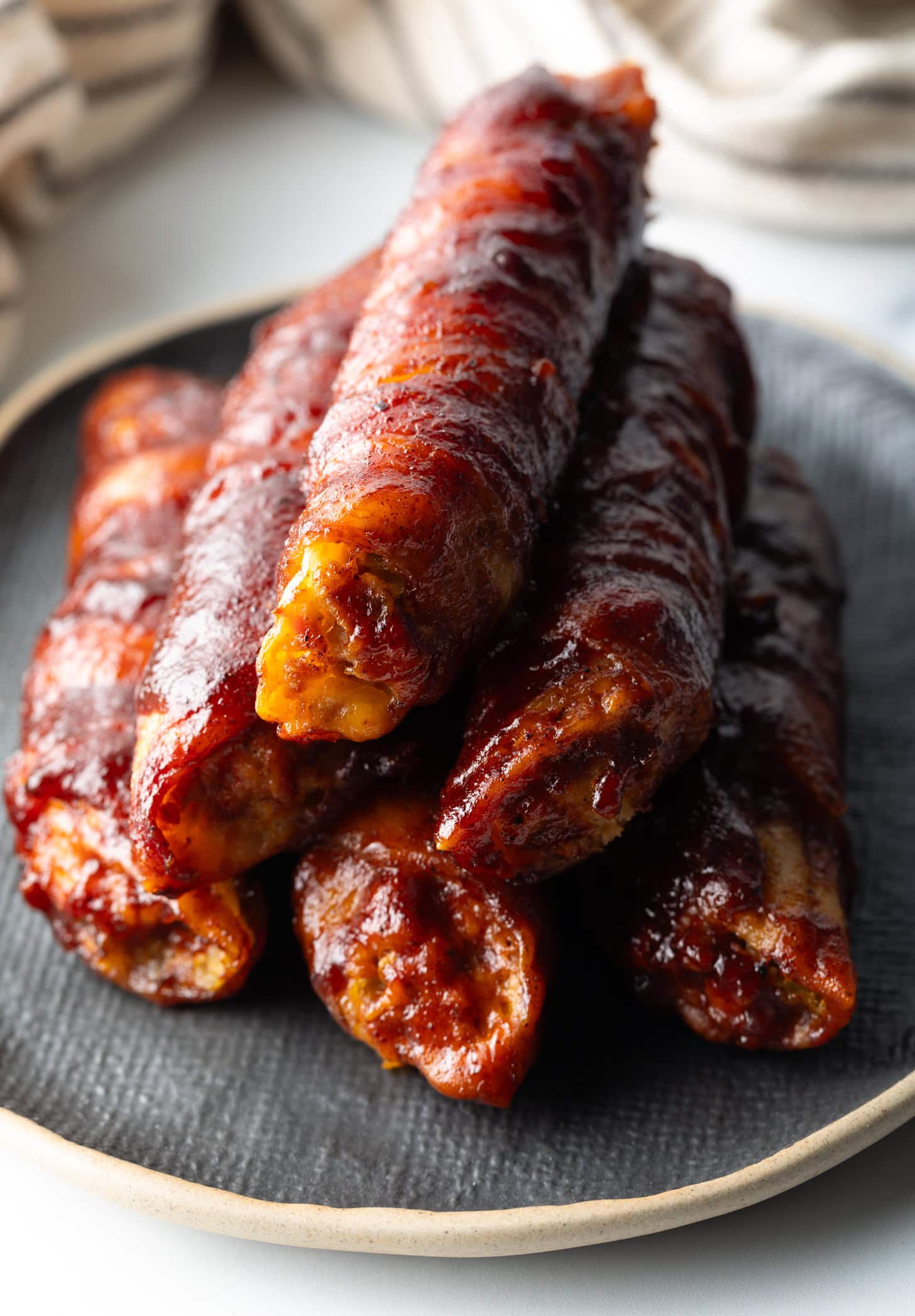 Pyramid tower of smoked shotgun shells on a gray plate.