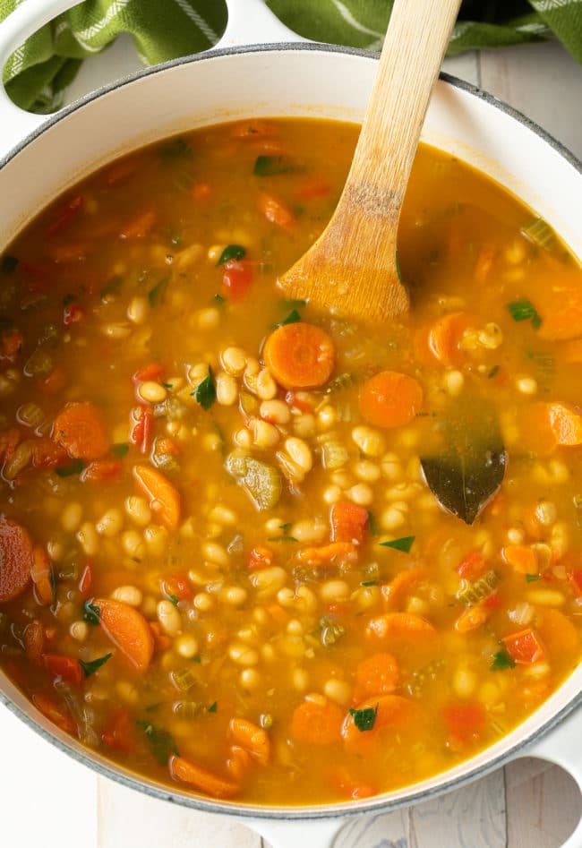 Overhead shot of vegetarian bean soup in a large dutch oven. 